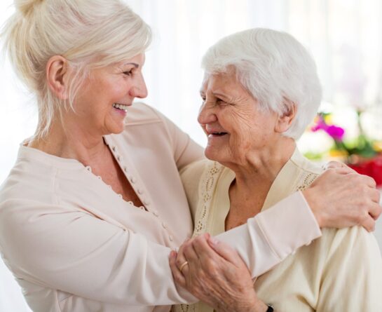 two mature women embracing