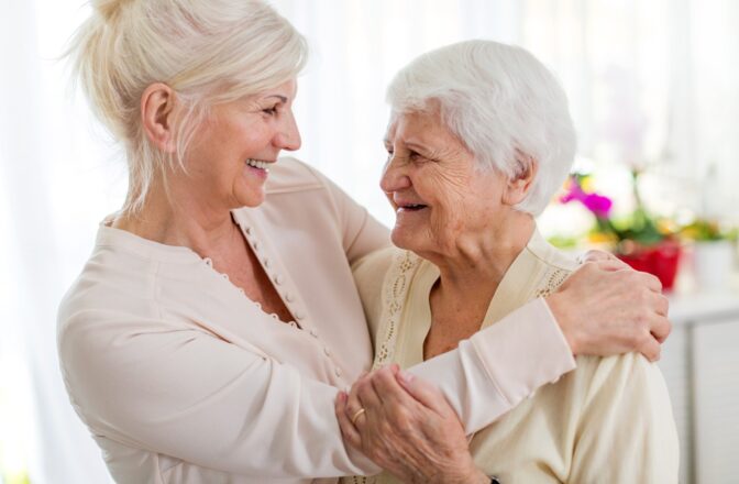 two mature women embracing