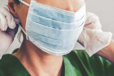 Healthcare professional putting on a face mask