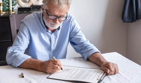 Mature man signing a contract