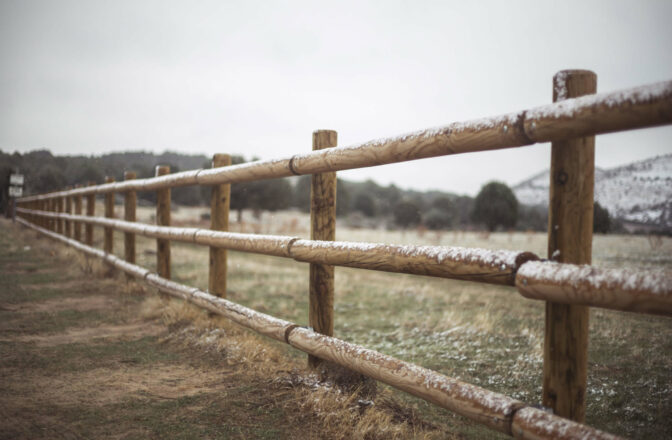 wood fence dusted with snow