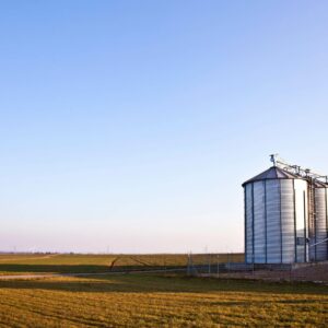 open field and sky with new grain bins