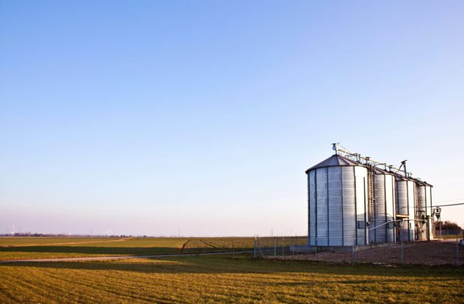 open field and sky with new grain bins