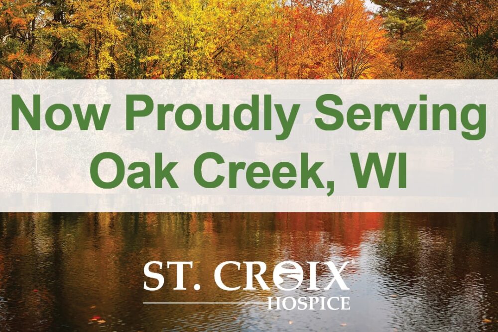 Text informing that St. Croix Hospice now serves Oak Creek area with autumn trees and lake in the background