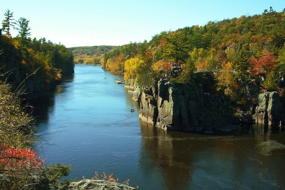 St. Croix river with green and orange trees on the side