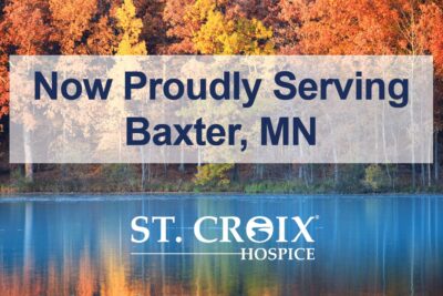 Text informing that St. Croix Hospice now serves Baxter area with lake and autumn trees in the background