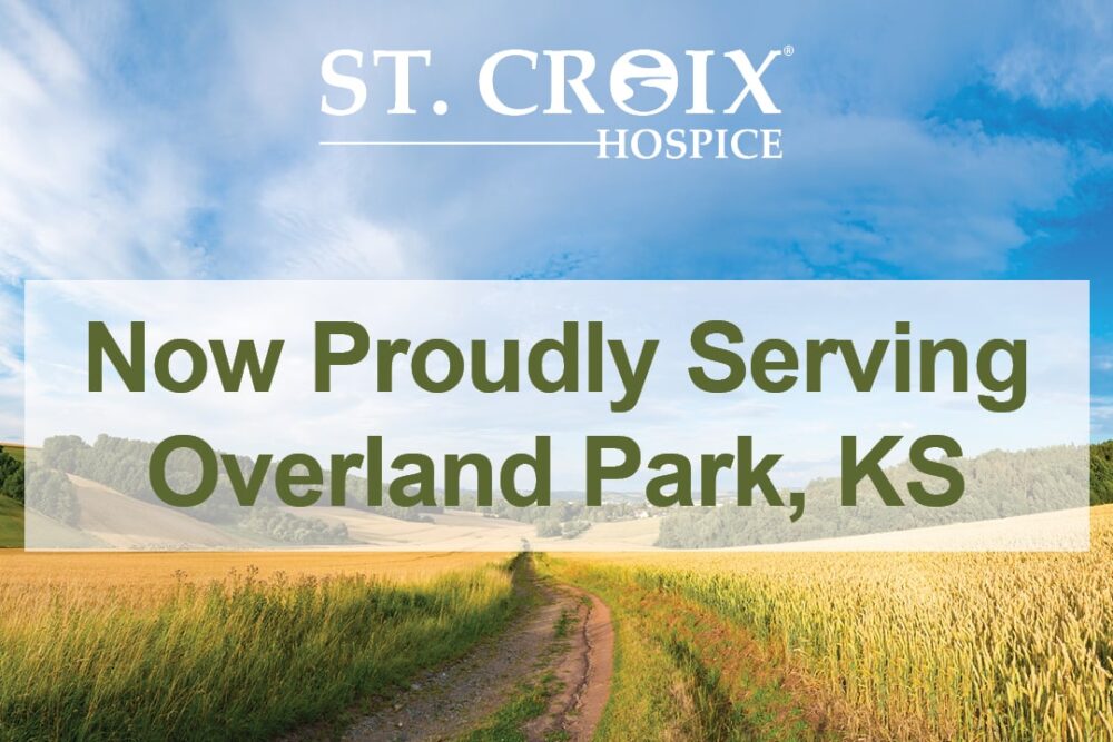 Text informing that St. Croix Hospice now serves Overland Park area with wheat field and green mountains in the background