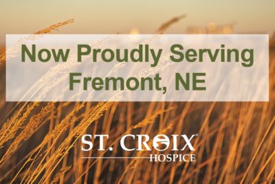 Text informing that St. Croix Hospice now serves Fremont with yellow wheat leaves in the background