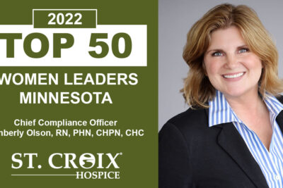 Executive woman smiling at camera with text that informs her leadership recognition