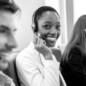 Woman wearing headphones and microphone while smiling and looking at the camera