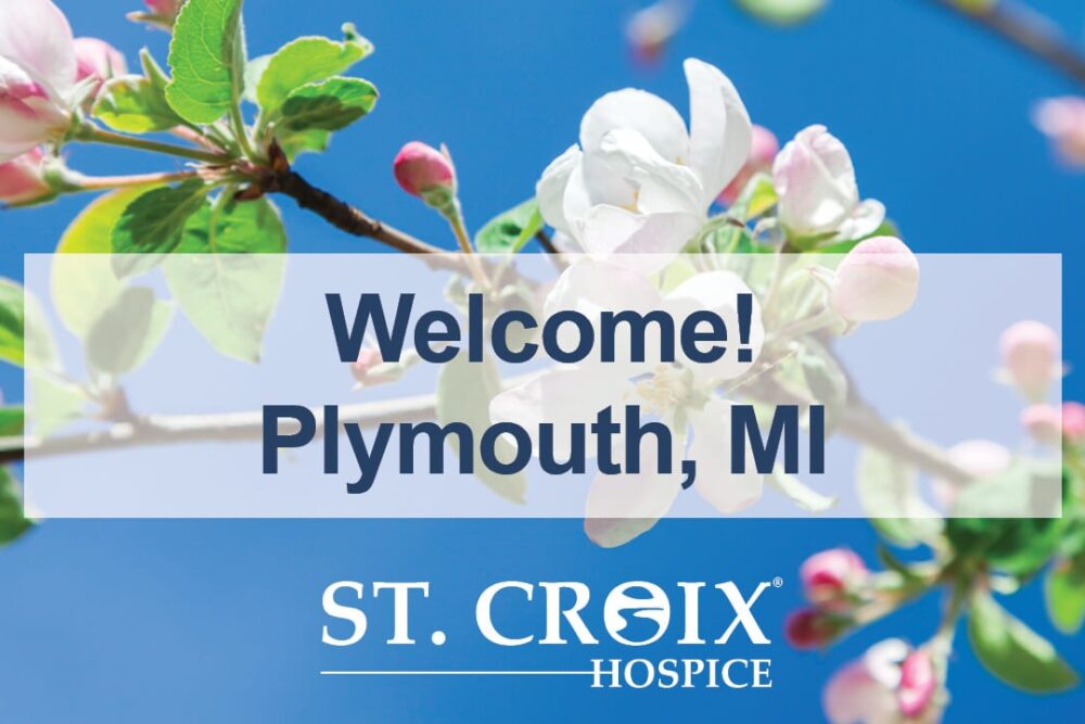 Text informing that St. Croix Hospice now serves Plymouth area with pink flowers on branches as background