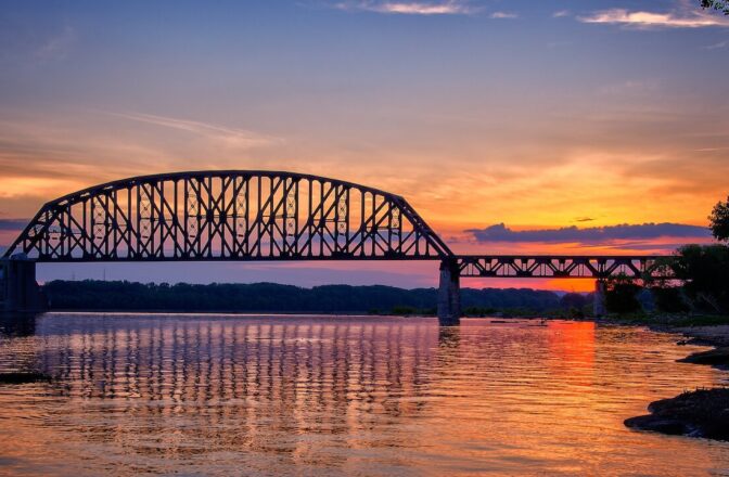 View of bridge over a river while the sun is setting