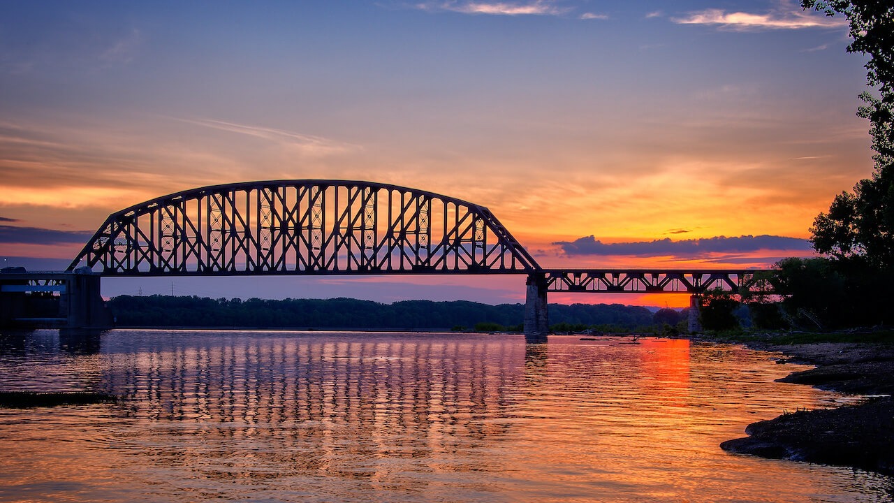View of bridge over a river while the sun is setting