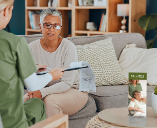 Female senior going through paperwork with St. Croix Hospice nurse